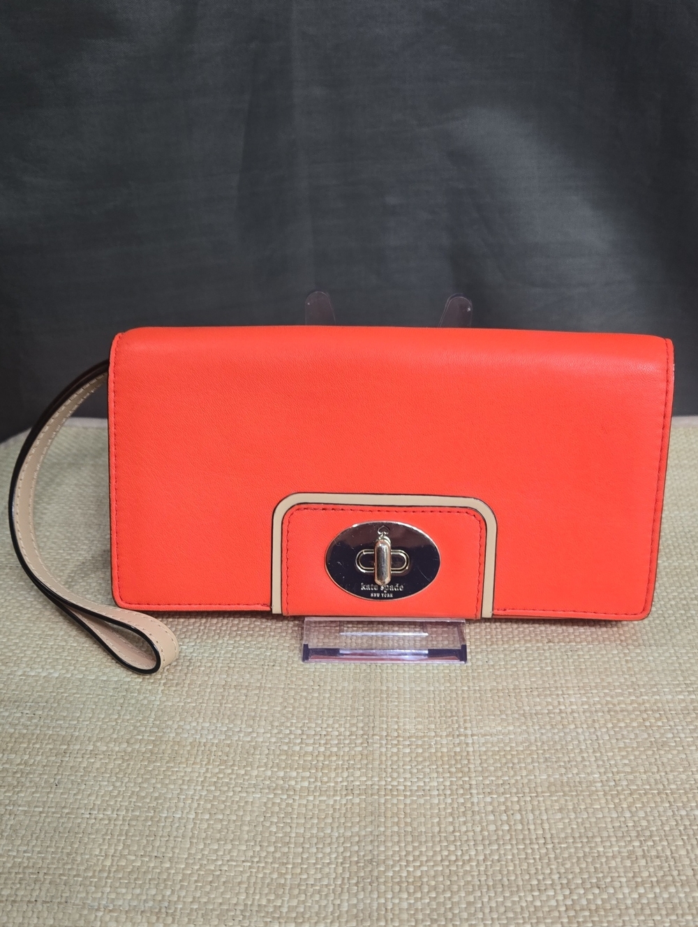 kate spade Orange wristlet with polished turnlock
